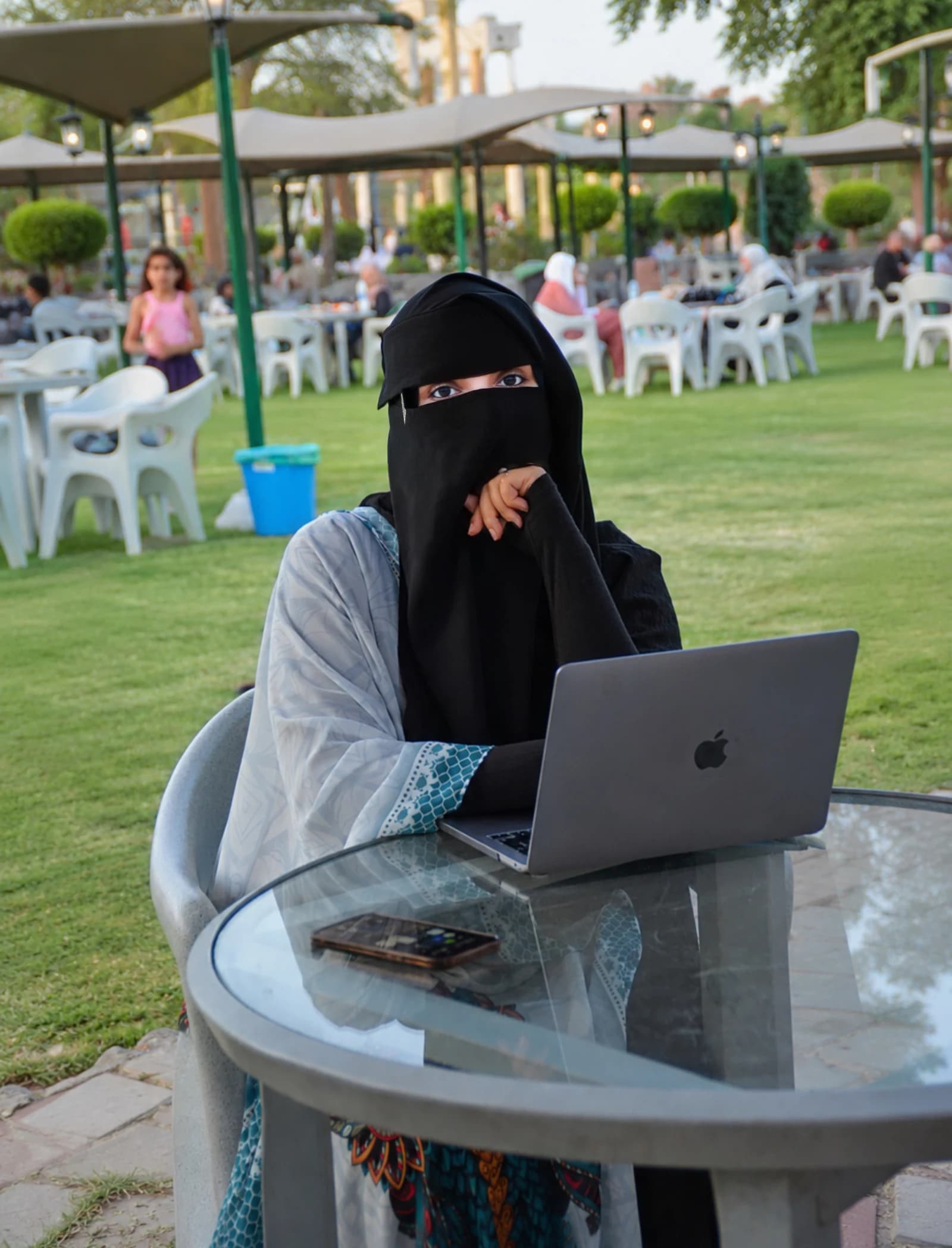 ياسمين مجد تعمل على حاسوبها المحمول في مكان مفتوح